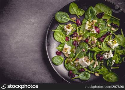 Spinach salad with sheep's cheese, cranberries and pine nuts