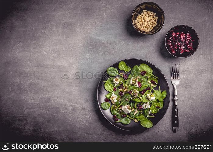 Spinach salad with sheep's cheese, cranberries and pine nuts