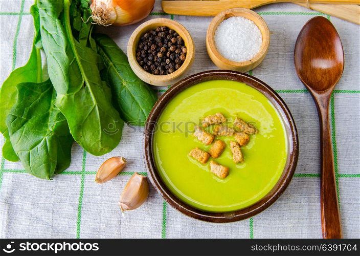 Spinach soup served on wooden board