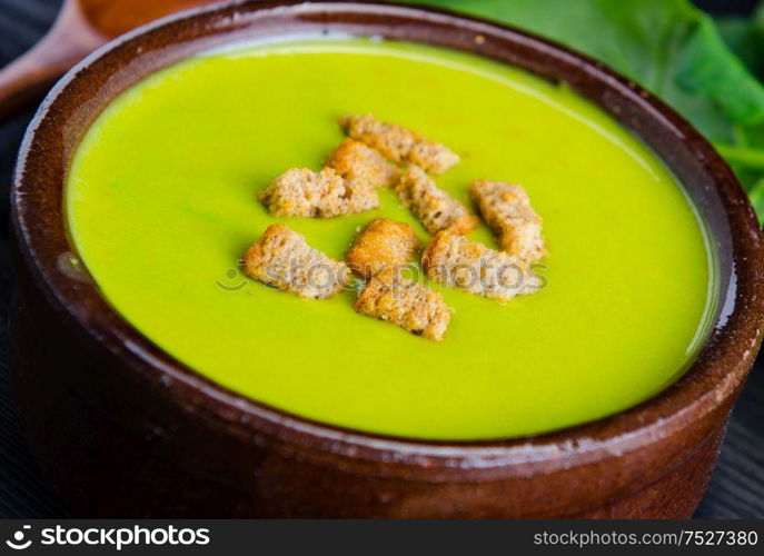 Spinach soup served on wooden board. The spinach soup served on wooden board