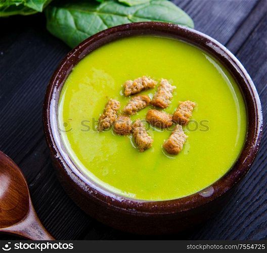 Spinach soup served on wooden board. The spinach soup served on wooden board