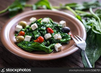Spinach with cheese, olives