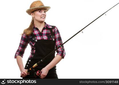 Spinning, angling, cheerful fisherwoman concept. Happy woman in sun hat holding fishing rod, having fun and smiling.. Happy woman in sun hat holding fishing rod