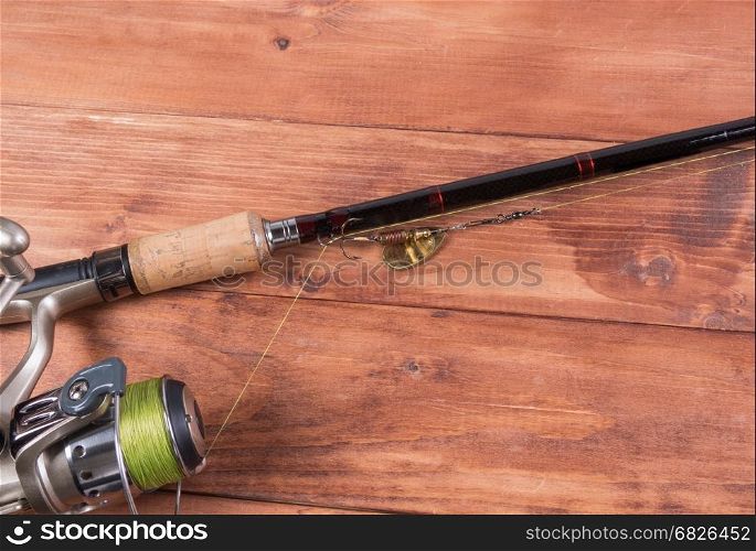 Spinning, baubles on a wooden background. Fishing equipment
