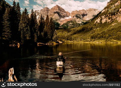 Spinning fishing (lure fishing) trout in lakes of the world. Brook trout (steelhead rainbow trout, char, bull-trout, cutthroat, lax, salmon and pink salmon caught on rotating spinner, close up photography