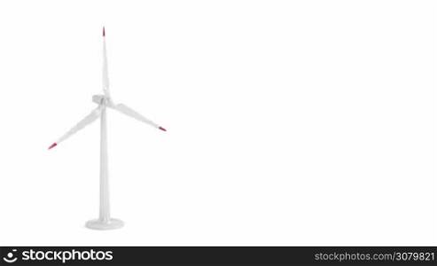 Spinning wind turbine on white background