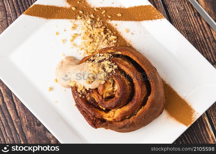 Spiral apple cake or muffin with cup of fresh coffee on wooden background