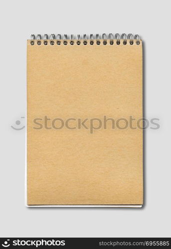 Spiral closed notebook mockup, brown paper cover, isolated on grey. Spiral closed notebook mockup
