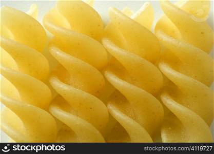 Spiral fusilli dired pasta macro over white