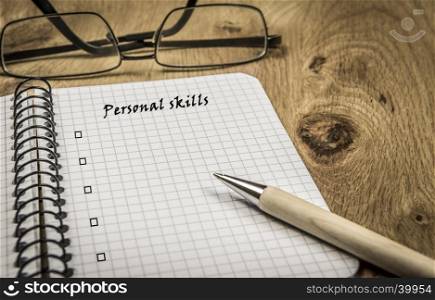 Spiral maths notebook with copy space for personal skills list, on a retro wooden desk