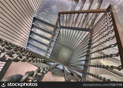Spiral metal staircase and metal steps inside the building. spiral metal staircase