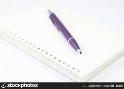 Spiral notebook and pen isolated on white background, stock photo