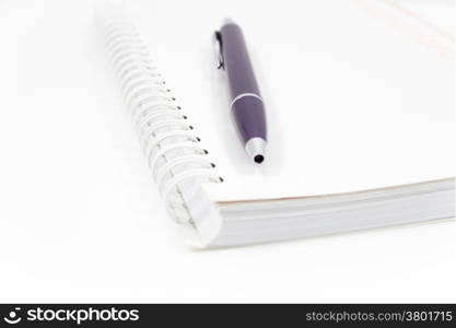 Spiral notebook with pen isolated on white background, stock photo