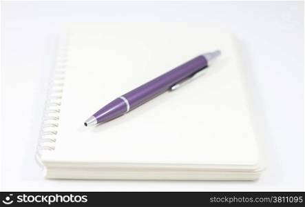 Spiral notebook with pen isolated on white background, stock photo