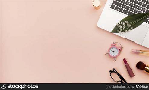 spiral notepad with lipstick alarm clock eyeglasses laptop against peach backdrop. Resolution and high quality beautiful photo. spiral notepad with lipstick alarm clock eyeglasses laptop against peach backdrop. High quality and resolution beautiful photo concept