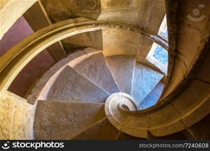 Spiral staircase in medieval Templar castle in Tomar in a beautiful summer day, Portugal