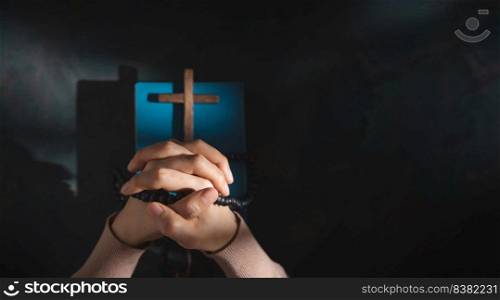 Spirituality, Religion and Hope Concept. Person Praying by Holy Bible and Cross on Desk. Symbol of Humility, Supplication,Believe and Faith for Christian People. Top View