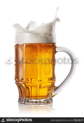 Splash in beer mug isolated on white background. Splash foam in faceted mug of light beer. Splash in beer mug