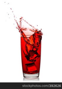 Splash of cherry juice from ice cubes in a transparent glass isolated on white background. Splash of cherry juice from ice cubes in transparent glass