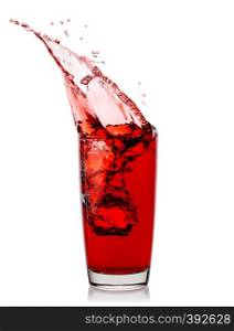 Splash of cherry juice in a glass isolated on a white background. Splash of cherry juice in glass