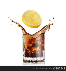 splash of cola in glass with lemon isolated on white