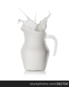 Splash of fresh milk in a glass jar isolated on white background. Splash of fresh milk in a glass jar