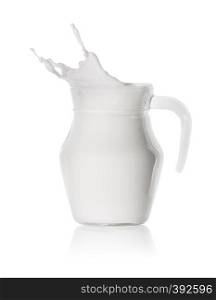 Splash of milk in a glass, transparent decanter isolated on a white background. Splash of milk in a glass transparent decanter