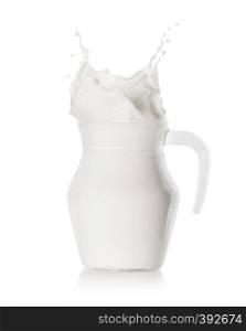 Splash of milk in filled glass jug isolated on white background. Splash of milk in a filled glass jug