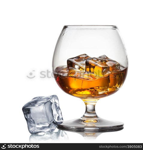 Splash of whiskey with ice in glass isolated on white background