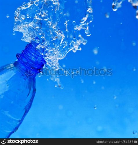 splash water from bottle on blue