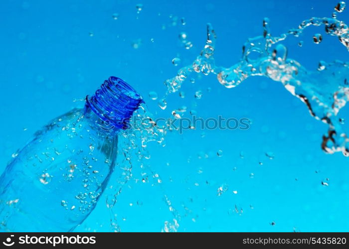 splash water from bottle on blue