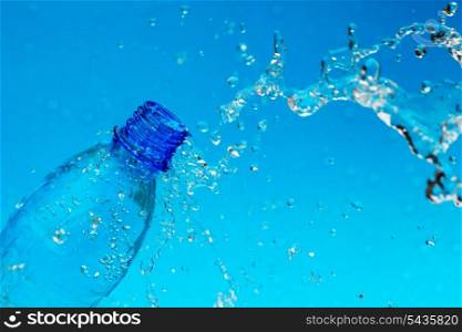 splash water from bottle on blue