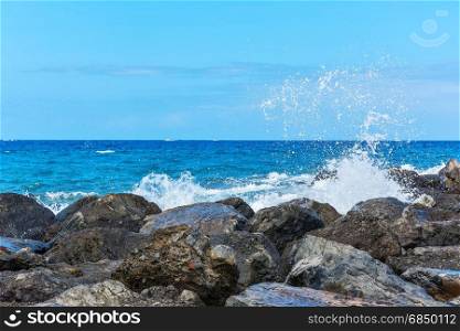 Splashes of water breaking on coastal rocks