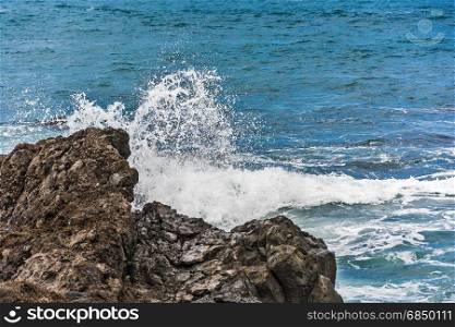 Splashes of water breaking on rocks