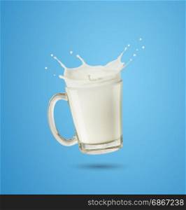 splashing milk in glass on blue background