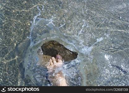 splashing water tourist feet on beach shore summer vacation metaphor
