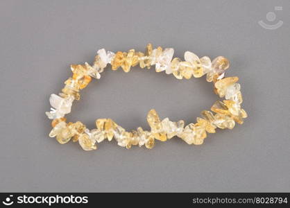 Splintered citrine chain on gray background