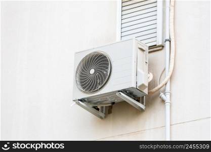 Split air conditioner outdoor unit hung outside the building