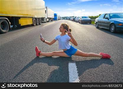 Split legs girl selfie photo in a traffic jam road having fun. Split legs girl selfie photo in a traffic jam road