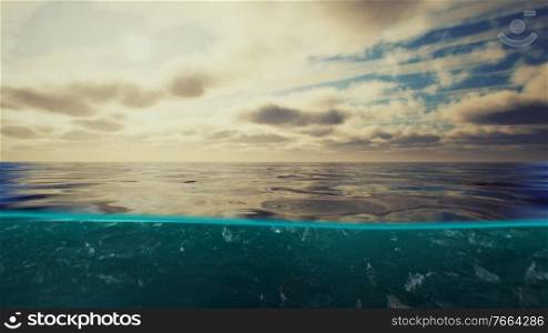 Split view over and under water in the Caribbean sea with clouds