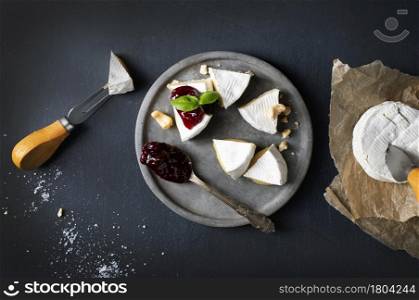 Splitted Camembert Cheese On Clay Plate With Jam