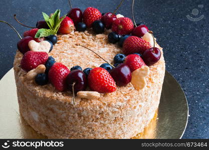 sponge cake with berries on dark background