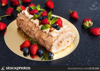 sponge cake with berries on dark background
