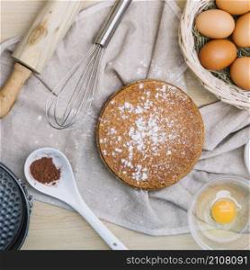 sponge cake with icing sugar ingredients wooden table