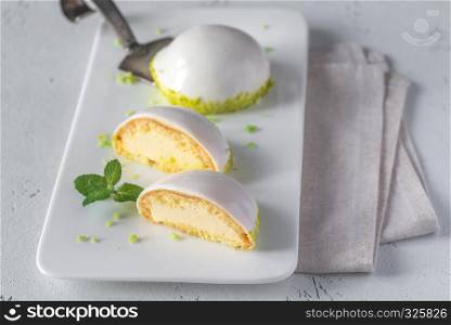Sponge cakes in yogurt glaze with pistachio crumbles