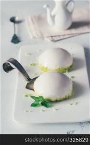 Sponge cakes in yogurt glaze with pistachio crumbles