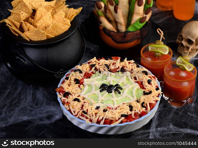 Spooky Halloween Seven Layer Taco Dip: Turn a classic appetizer into a Halloween with of black olive spider .