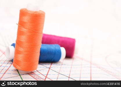 Spool of thread. Sew accessories on blurred background