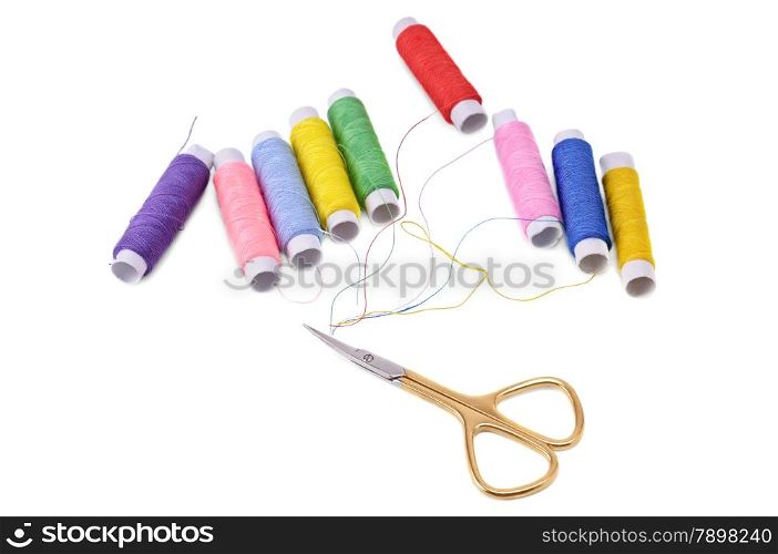 spools of thread and scissors isolated on white background