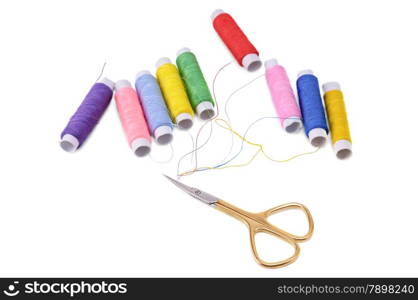 spools of thread and scissors isolated on white background